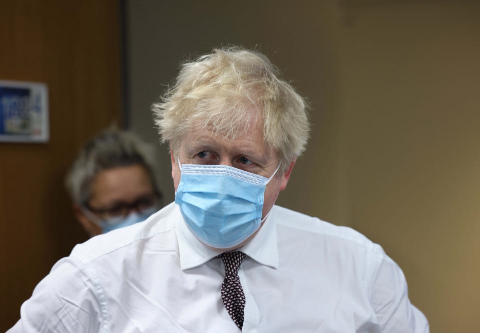 Britain's Prime Minister Boris Johnson looks on during a visit to Finchley Memorial Hospital, in North London, Tuesday, Jan. 18, 2022. (Ian Vogler, Pool Photo via AP)