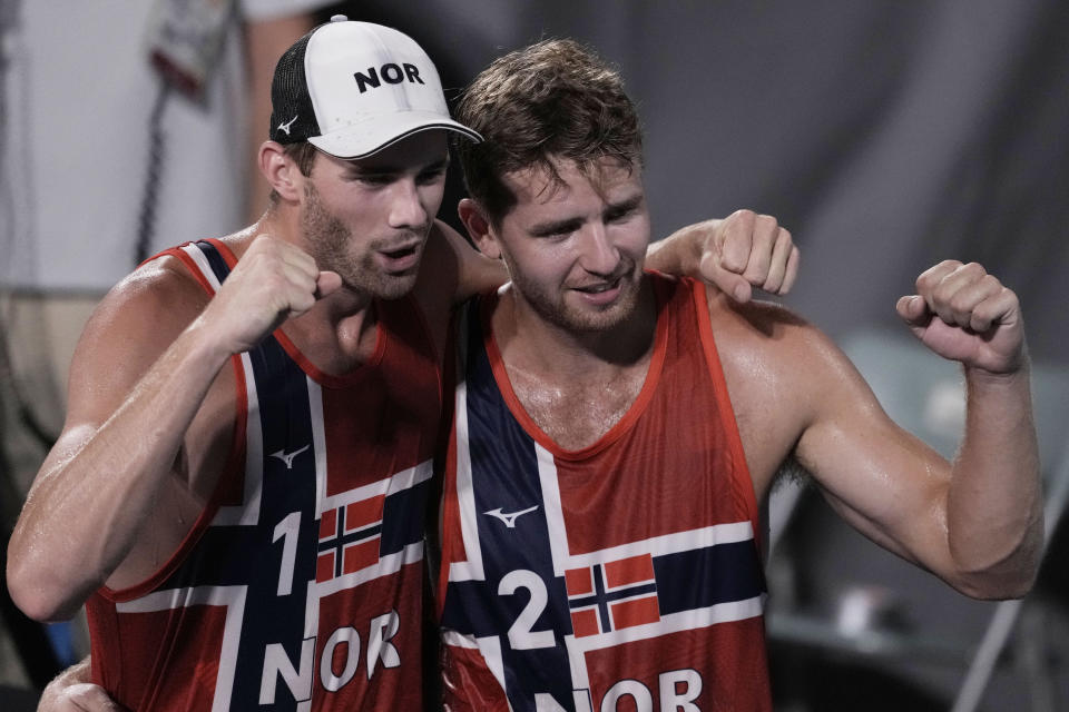 Anders Berntsen Mol, left, of Norway, and teammate Christian Sandlie Sorum, celebrate winning a men's beach volleyball semifinal match against Latvia at the 2020 Summer Olympics, Thursday, Aug. 5, 2021, in Tokyo, Japan. (AP Photo/Petros Giannakouris)