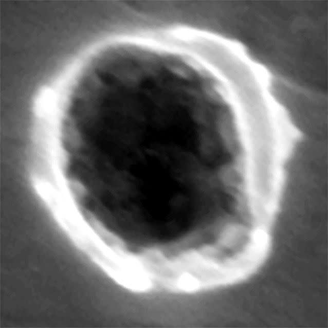 This undated image provided by the journal Science via Stardust shows the view of a dust particle impact on Al foil collector. Source: AP Photo/Science via Stardust ISPE/ NRL