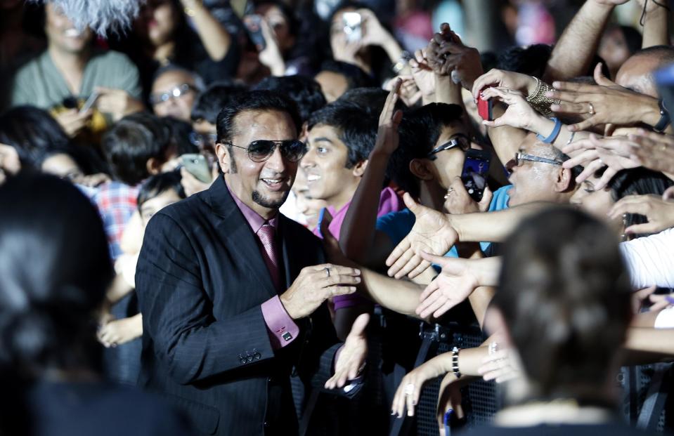 Indian film star Gulshan Grover walks the green carpet as he arrives for the 15th annual International Indian Film Awards on Saturday, April 26, 2014, in Tampa, Fla. (AP Photo/Brian Blanco)