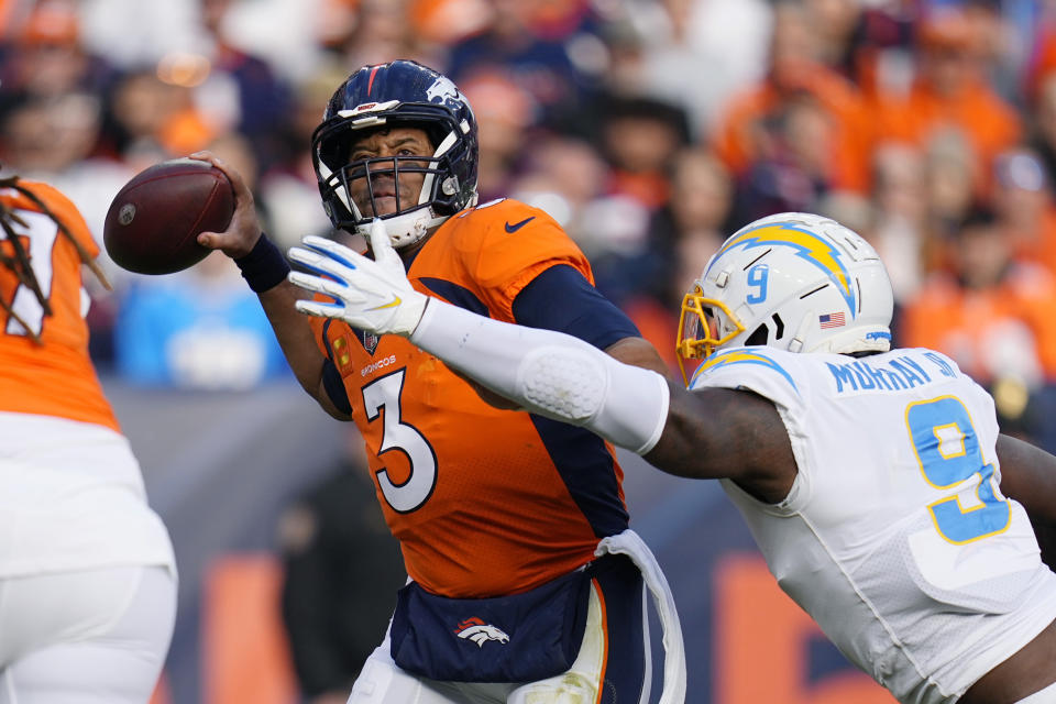 Denver Broncos quarterback Russell Wilson (3) is pressured by Los Angeles Chargers linebacker Kenneth Murray Jr. (9) has he throws during the first half of an NFL football game in Denver, Sunday, Jan. 8, 2023. (AP Photo/Jack Dempsey)