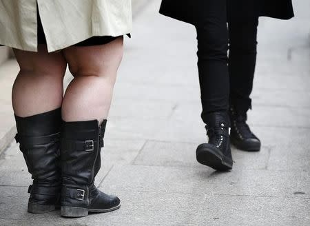 The legs of women are pictured as they walk along a street in Paris, France, October 14, 2015. REUTERS/Jacky Naegelen/Files