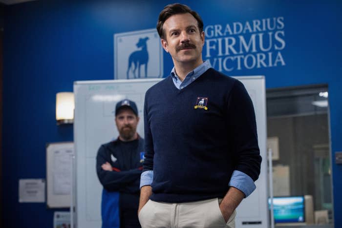 coach ted lasso standing in a locker room