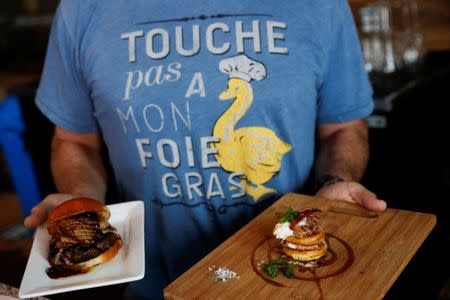 FILE PHOTO: The Hot's Kitchen "Foie Burger" (L), made with foie gras, brie, huckleberry, and whole grain mustard, and "Leggo My Foie", made with foie gras, waffle, vanilla maple syrup, bacon, and whipped cream, are displayed by chef Sean Chaney at Hot's Kitchen in Hermosa Beach, California January 10, 2015. REUTERS/Patrick T. Fallon/File Photo