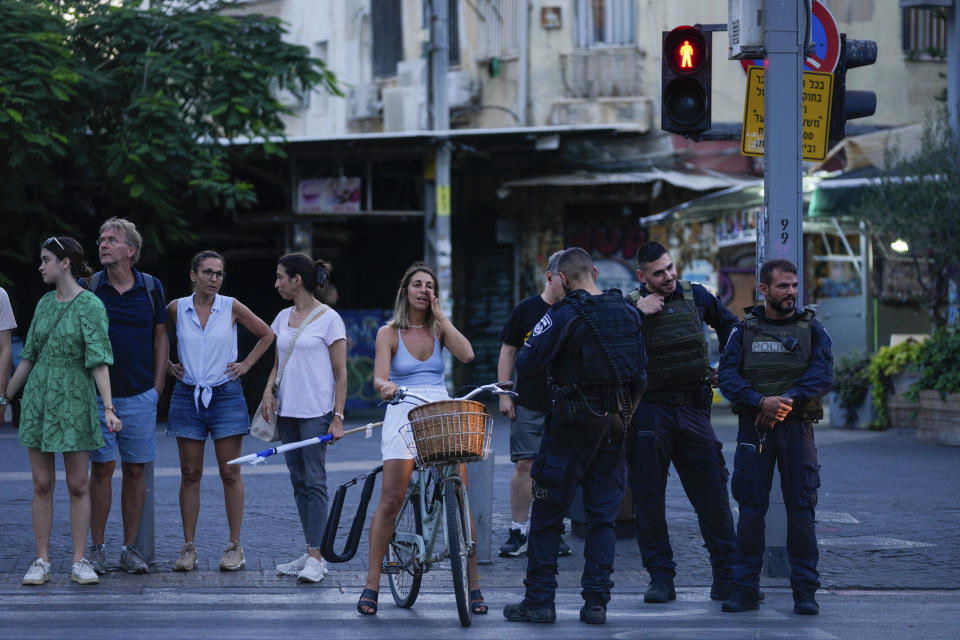 Israeli police inspect the site of a shooting attack in Tel Aviv, Israel, Saturday, Aug 5, 2023. Israeli authorities said Saturday that a Palestinian gunman opened fire in central Tel Aviv, critically wounding one person who was transferred to the hospital. The gunman was shot and received medical treatment for his wounds. (AP Photo/Maya Alleruzzo)