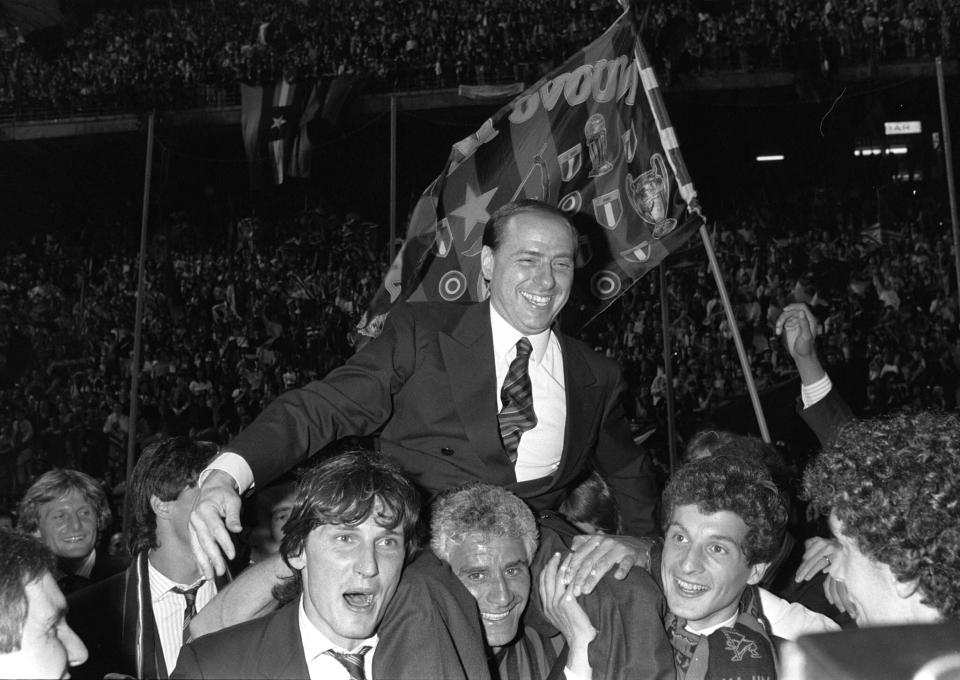 FILE - AC Milan president Silvio Berlusconi is shoulder-carried by Milan players after winning the 1988 Italian championship at the Milan's San Siro stadium. Berlusconi, the boastful billionaire media mogul who was Italy's longest-serving premier despite scandals over his sex-fueled parties and allegations of corruption, died, according to Italian media. He was 86. (AP Photo/Ferdinando Meazza, File)