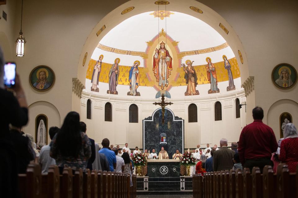 People attend a Catholic mass at the Corpus Christi Cathedral on Friday, June 24, 2022. Bishops from around Texas gathered to welcome Archbishop Christophe Pierre, the Vatican's apostolic nuncio to the United States, and celebrate the 110th anniversary of the Diocese of Corpus Christi.