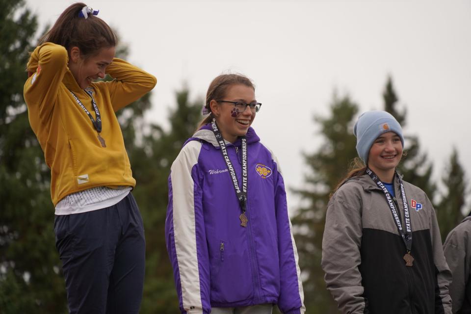 New Berlin Eisenhower's Faith Wehrman (center) returned to the podium a year after winning the WIAA Division 2 girls state cross country meet, this year finishing sixth at The Ridges Golf Course in Wisconsin Rapids on Saturday Oct. 28, 2023.