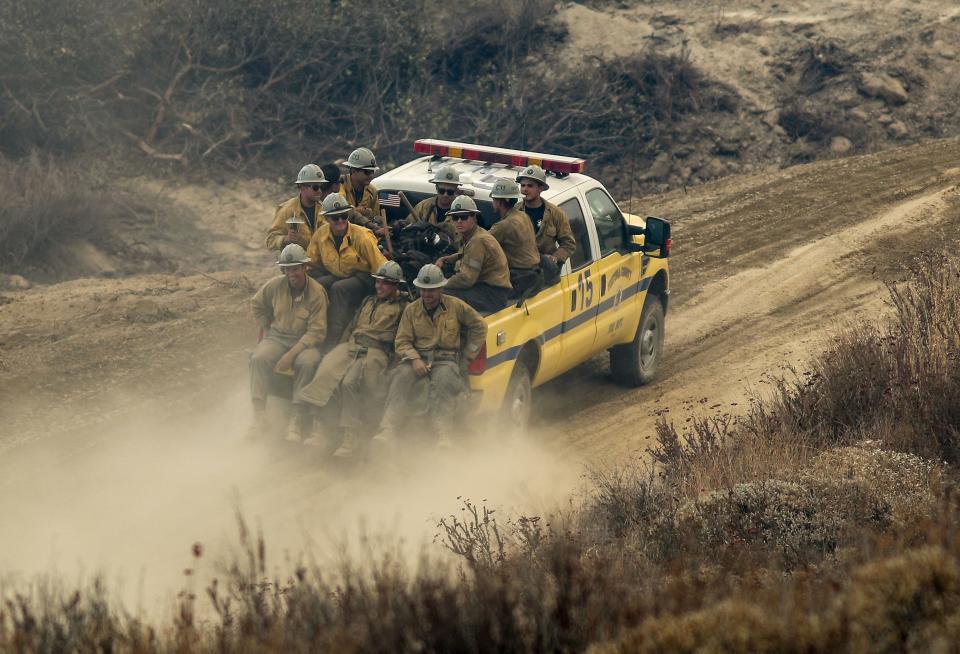 A hand crew heads toward the front lines of the Fairview Fire in a remote area south of Hwy 74 in the Cleveland National Forest, Sept. 8, 2022.