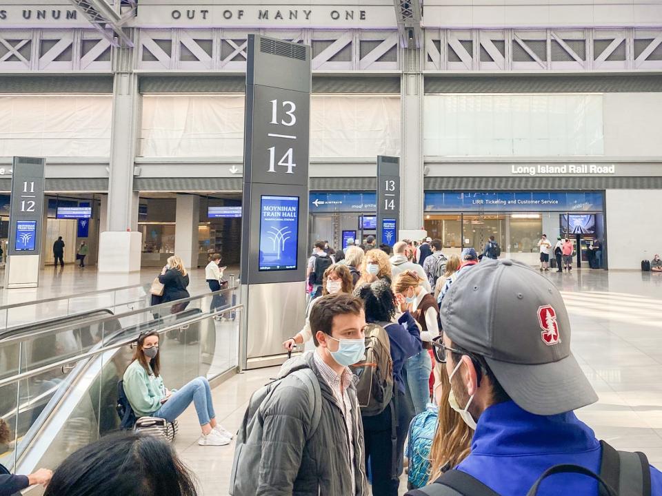 Travelers wait to board an Amtrak train in NYC’s Penn Station in October 2021.