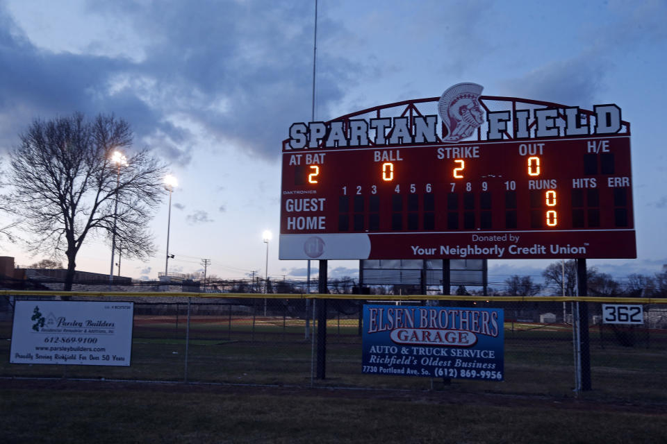 The baseball field scoreboard lights up the year at Richfield High School Wednesday night, April 8, 2020 in Richfield, Minn. Seeking to brighten spirits amid the virus outbreak, the symbolic act of turning on the lights became a movement — fueled by social media with the hashtag #BeTheLight — across the country. (AP Photo/Jim Mone)