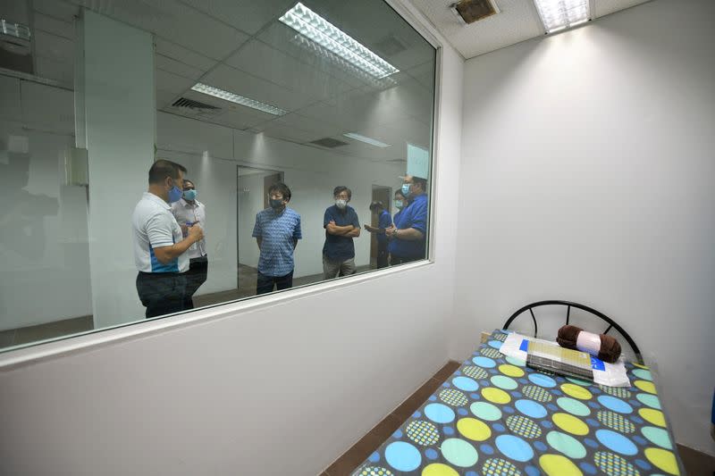 Singapore's Transport Minister Khaw Boon Wan is seen onboard a floating accommodation, meant to house healthy migrant workers, as the spread of the coronavirus disease (COVID-19) continues in Singapore