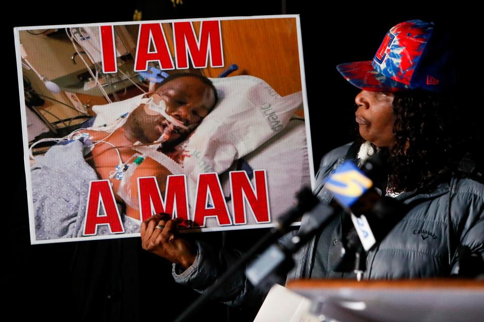 RowVaughn Wells, the mother of Tyre Nichols, looks at a photo of her son in the hospital during a candlelight vigil for Nichols held at the site where he was beaten to death by Memphis Police Department officers on the one year anniversary of his death in Memphis, Tenn., on Sunday, January 7, 2024.