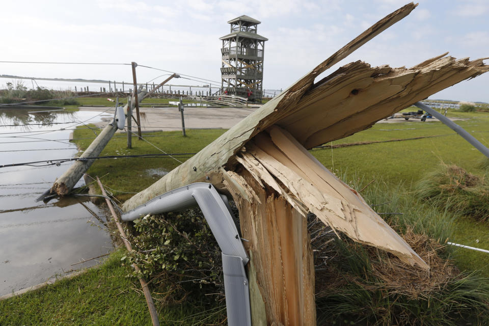 Utility poles were shipped after Hurricane Dorian moved through the area yesterday along a causeway in Nags Head, NC., Saturday, Sept. 7, 2019. (AP Photo/Steve Helber)