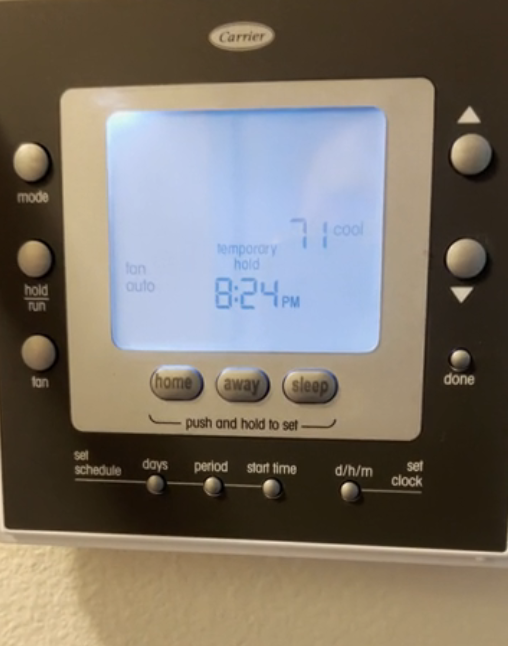 Programmable thermostat on wall