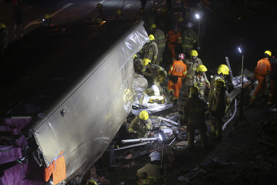 <p>Emergency workers prepare to rescue injured passengers from a double-decker lying on its side in Hong Kong on Feb. 10, 2018. (Photo: AP) </p>