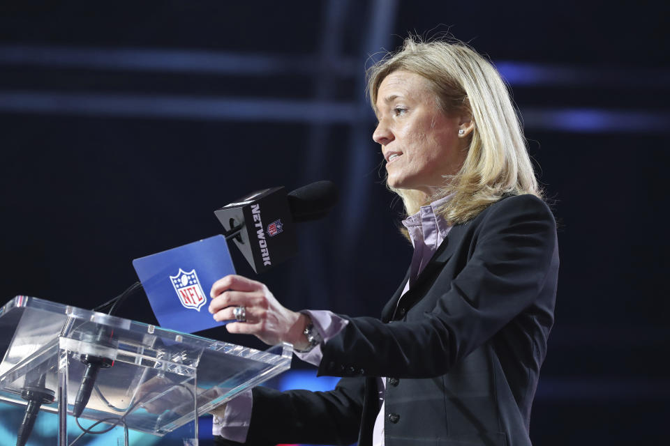 FILE - NFL Chief Football Administrative Officer Dawn Aponte announces a selection during the third round of the NFL football draft, Friday April 29, 2021, in Cleveland. From front offices to personnel departments to coaching staffs, the league is finally mirroring society as women are getting jobs that once went only to men. Thanks to women like Dawn Aponte, barriers are gone. “The godmother,” Sam Rapoport, the league's Senior Director of Diversity, Equity and Inclusion, said of Aponte. “We're all standing on Dawn's shoulders.”(AP Photo/Gregory Payan, File)