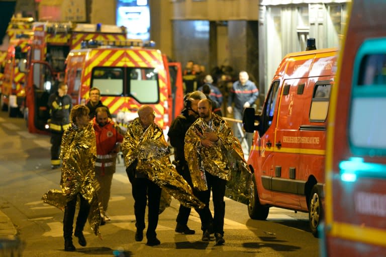 People are being evacuated on rue Oberkampf near the Bataclan concert hall in central Paris, early on November 14, 2015