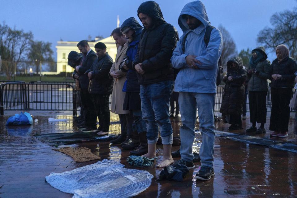 Protesters pray during a demonstration in support of Palestinians, Tuesday, April 2, 2024, at Lafayette Park across from the White House in Washington,. (AP Photo/Jose Luis Magana)