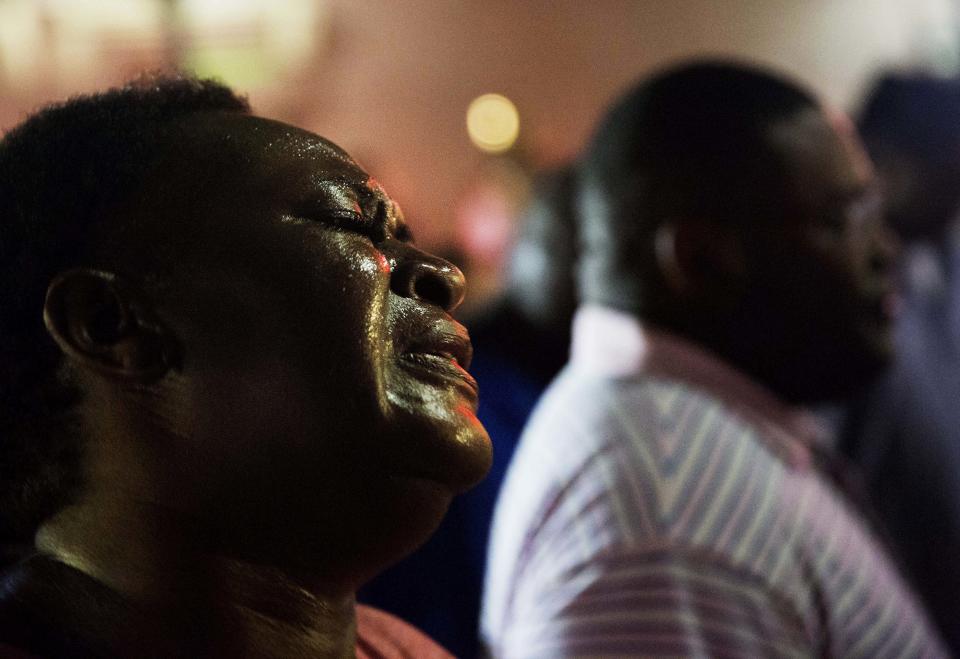 Lisa Doctor joins a prayer circle early Thursday, June 18, 2015, down the street from Emanuel following the shooting. 