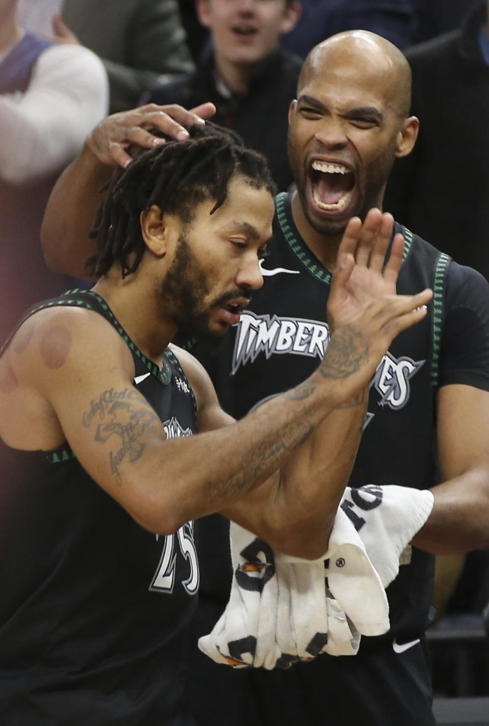 Minnesota Timberwolves' Taj Gibson, right congratulates Derrick Rose after the Timberwolves defeated the Utah Jazz 128-125 in an NBA basketball game Wednesday, Oct. 31, 2018, in Minneapolis. Rose had a career-high 50 points. (AP Photo/Jim Mone)