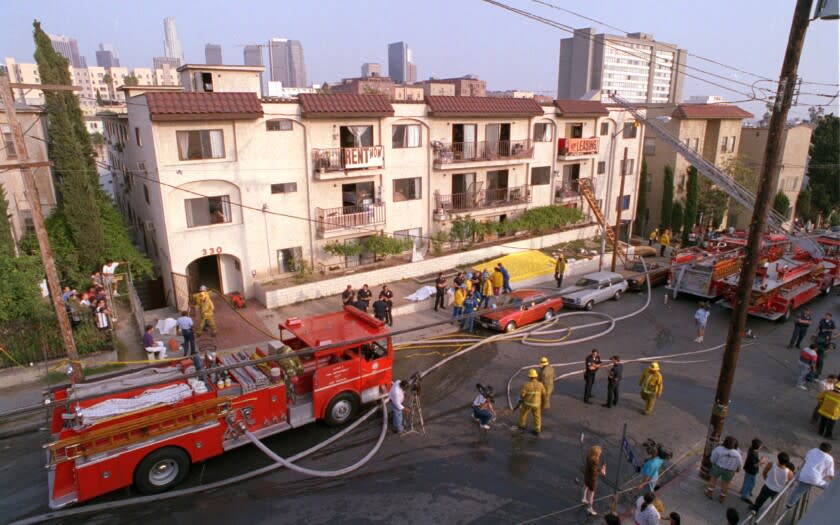 Fire and rescue personnel outside 3-story apartment house in L.A.'s Westlake section after fatal blaze. ME.Fire.#1.AS.5-4 Building on Burlington which burned killing at least 10 in yesterdays fire.