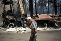 <p>A man walks past the remains of his truck, which was destroyed during a forest fire in Figueiro dos Vinhos, Portugal, June 18, 2017. (Patricia De Melo Moreira/AFP/Getty Images) </p>