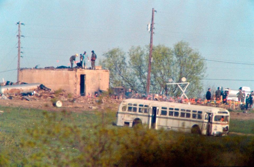 Texas investigators search the rubble of the burned-out compound and mark body locations with small flags on April 22, 1993. <a href="https://www.gettyimages.com/detail/news-photo/texas-department-of-safety-investigators-and-medical-news-photo/176613642?phrase=waco%20davidian&adppopup=true" rel="nofollow noopener" target="_blank" data-ylk="slk:J. David Ake/AFP via Getty Images;elm:context_link;itc:0;sec:content-canvas" class="link ">J. David Ake/AFP via Getty Images</a>