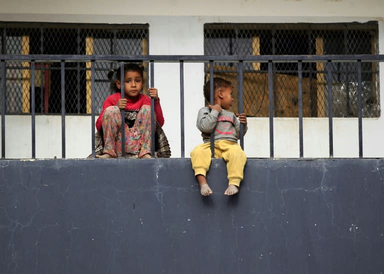 Yemeni children from Hodeida sit outside a school in the capital Sanaa that has been converted into temporary housing for displaced families