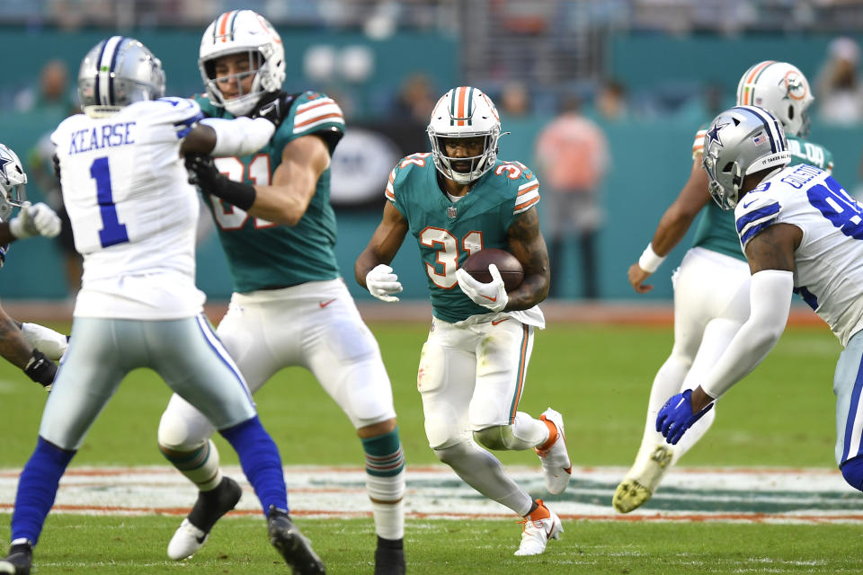 Miami Dolphins running back Raheem Mostert (31) runs with the football during the first half of an NFL football game against the Dallas Cowboys, Sunday, Dec. 24, 2023, in Miami Gardens, Fla. (AP Photo/Michael Laughlin)