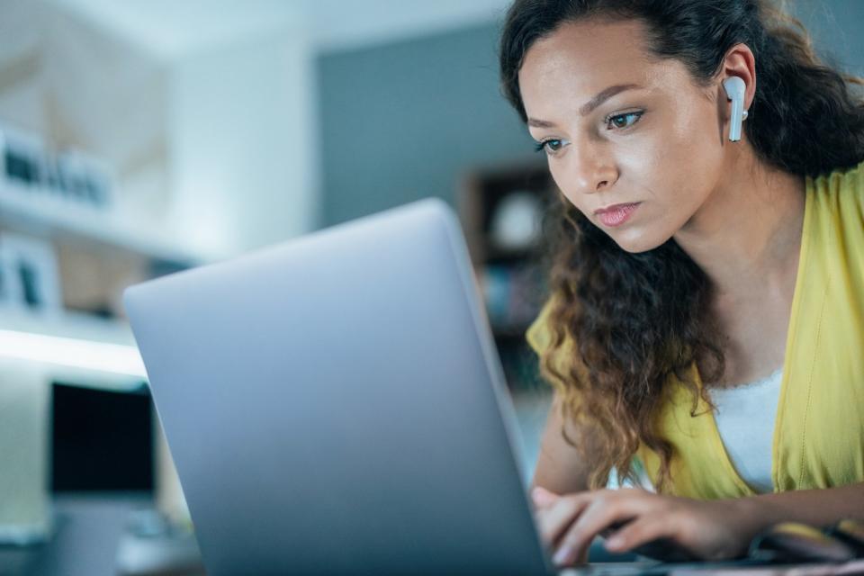 An investor works on a laptop at home.