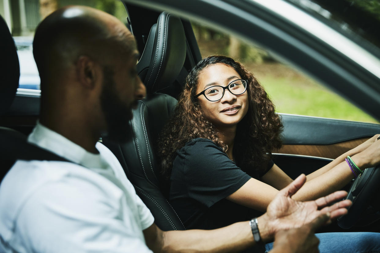 Driving is a big moment for all three of you: your teen, yourself and your wallet. Save money on car insurance with these tips for parents.  (Thomas Barwick via Getty Images)