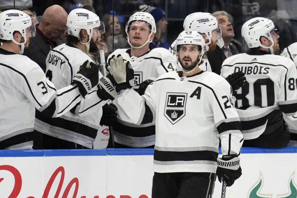 Los Angeles Kings center Phillip Danault (24) celebrates with the bench after his goal against the Tampa Bay Lightning during the second period of an NHL hockey game Tuesday, Jan. 9, 2024, in Tampa, Fla. (AP Photo/Chris O'Meara)