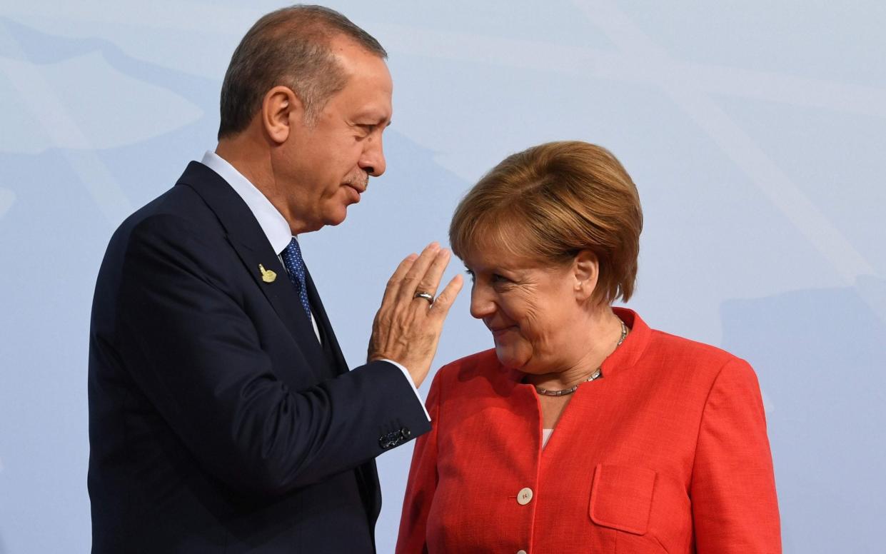 Angela Merkel greets Turkey's President Recep Tayyip Erdogan in 2018 (file photo)  - Bernd Von Jutrczenka / POOL / AFP