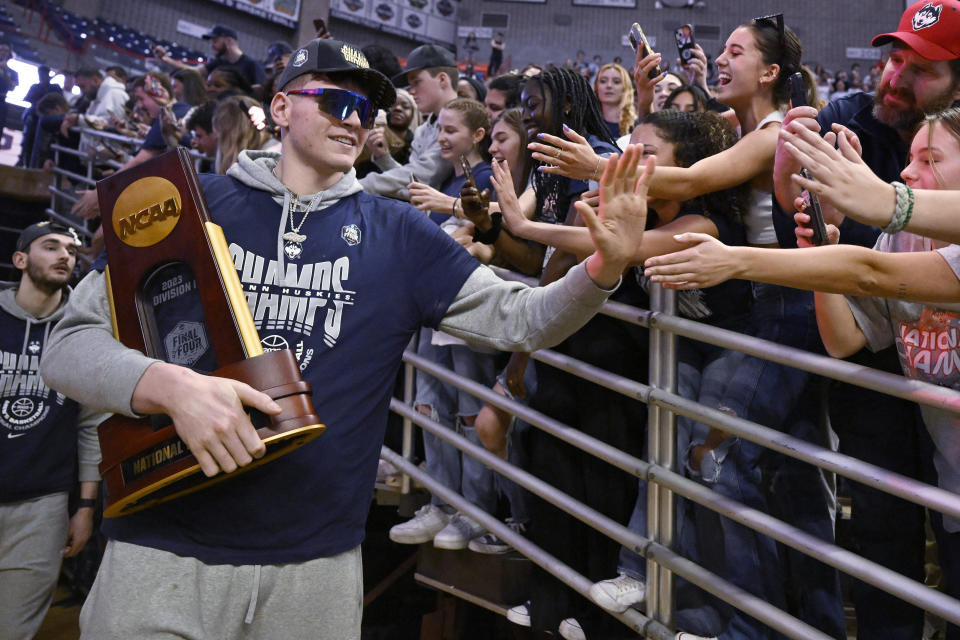 UConn's Donovan Clingan is greeted by fans as the team arrives for a rally at Gampel Pavilion in honor of UConn's NCAA men's Division I basketball championship, Tuesday, April 4, 2023, in Storrs, Conn. (AP Photo/Jessica Hill)