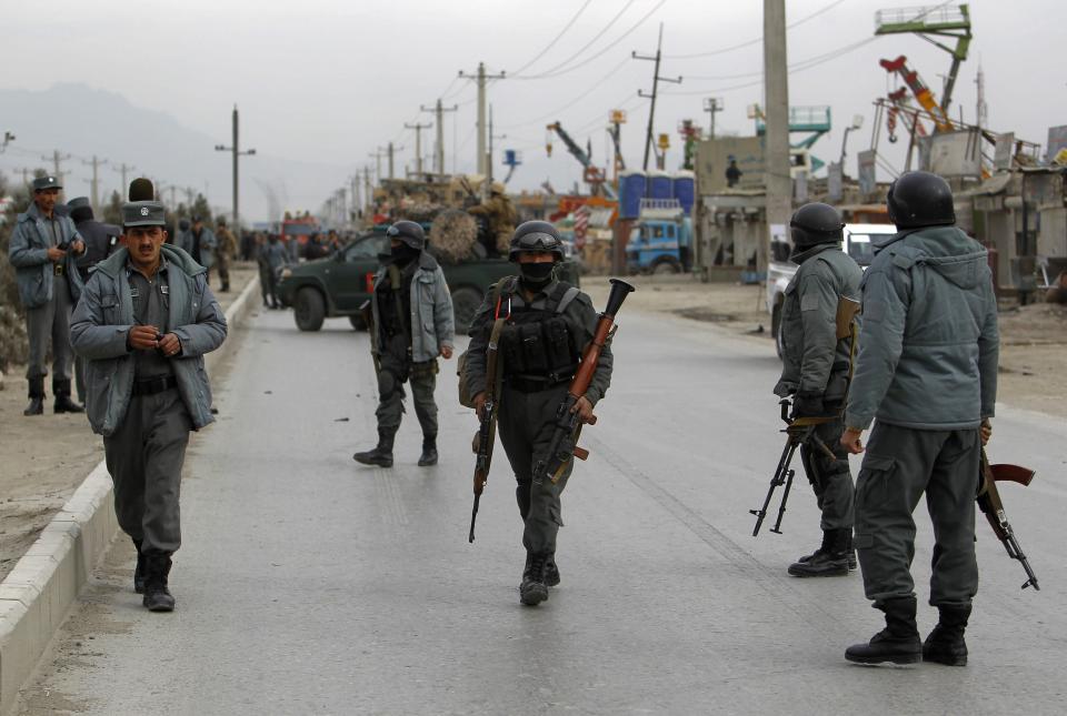 Afghan policemen arrive at the site of a bomb attack in Kabul