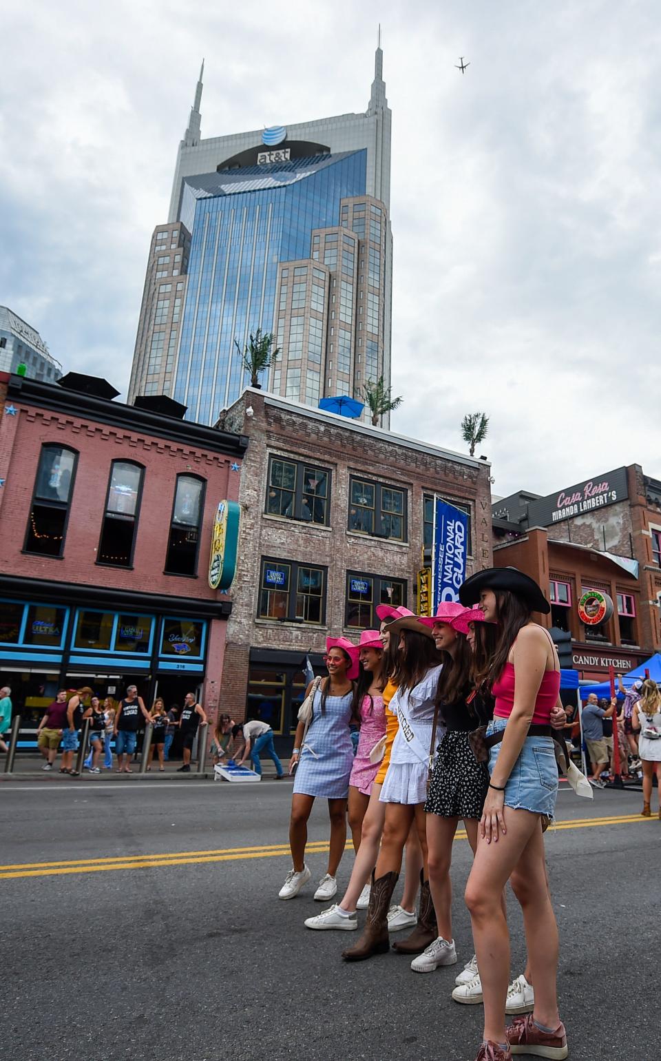 A group of bachelorettes pose for a photo on Broadway in 2022 during CMA Fest in Nashville.