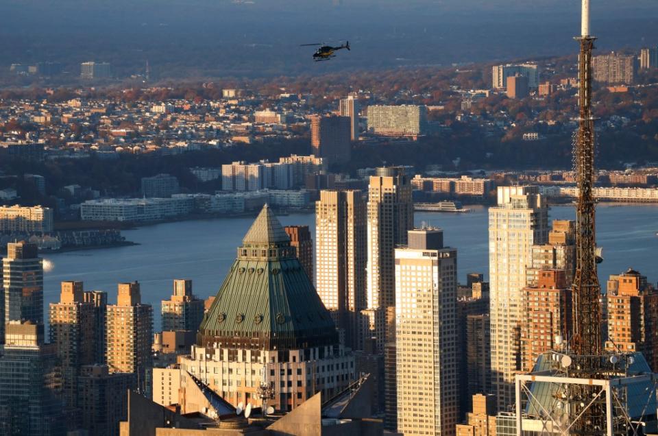 A helicopter flies over Midtown Manhattan at sunset on Nov. 12, 2023. Getty Images