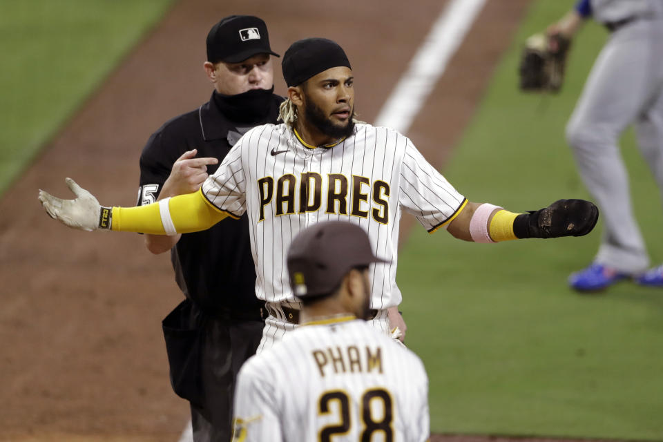 San Diego Padres' Fernando Tatis Jr. reacts after being tagged out while trying to score from third base off a line out by Manny Machado during the seventh inning of a baseball game against the Los Angeles Dodgers, Monday, Aug. 3, 2020, in San Diego. (AP Photo/Gregory Bull)