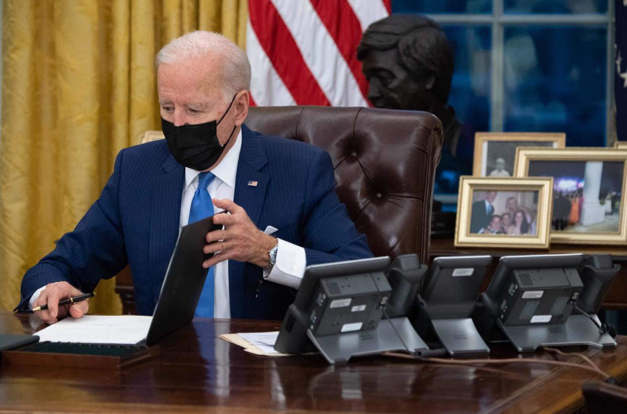 <p>US President Joe Biden signs executive orders related to immigration in the Oval Office of the White House in Washington, DC, February 2, 2021. </p> ((Photo by SAUL LOEB/AFP via Getty Images))