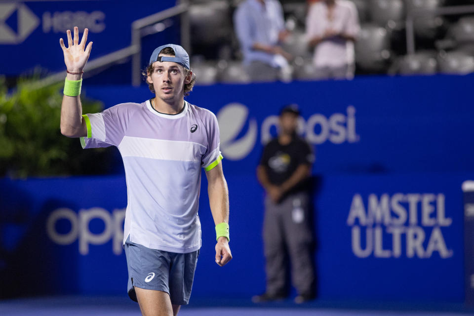 Alex De Minaur waves to the crowd.