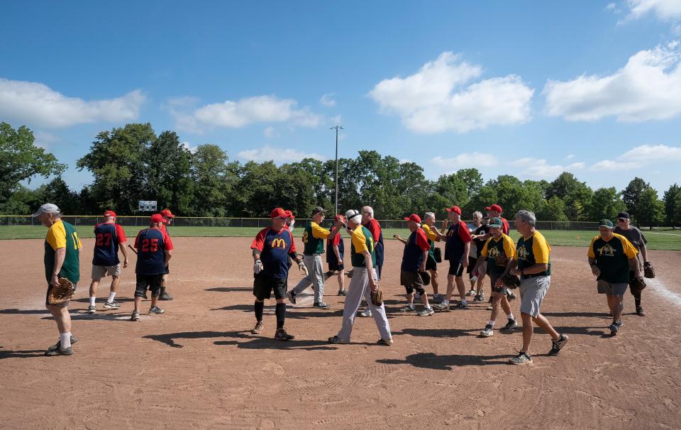 Jul 13, 2023; Hilliard, Ohio, USA;  Players high five at the end of the game following the Thursday games of the Central Ohio Senior Softball Association at the Roger A. Reynolds Municipal Park. 