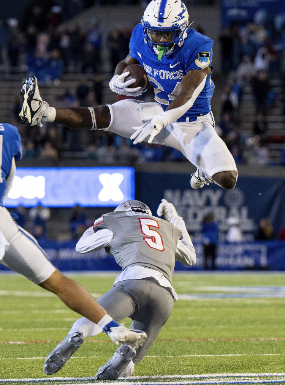 Air Force running back John Lee Eldridge III (24) leaps over UNLV defensive back Cameron Oliver (5) during the second half of an NCAA college football game Saturday, Nov. 18, 2023, at Air Force Academy, Colo. (Parker Seibold/The Gazette via AP)