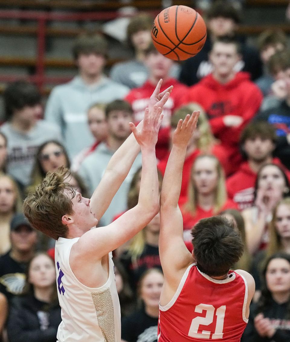 Brownsburg Bulldogs Grant Porath (11) reaches for a lya-up against New Palestine Dragons Eian Roudebush (21) on Saturday, March 11, 2023 at Southport High School in Indianapolis. The Brownsburg Bulldogs defeated the New Palestine Dragons, 66-39, for the IHSAA Class 4A regional championship. 