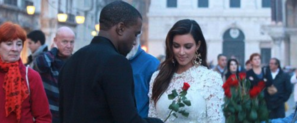 Kanye handing Kim a red rose