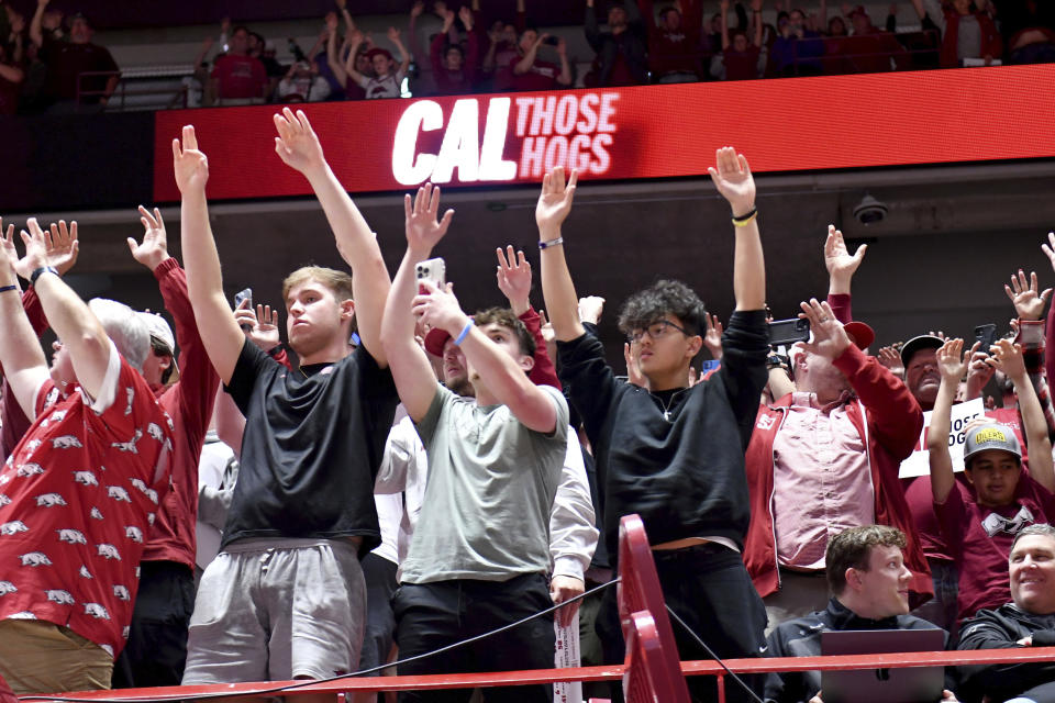 Arkansas fans call the hogs as John Calipari is introduced as men's basketball coach Wednesday, April 10, 2024, in Fayetteville, Ark. (AP Photo/Michael Woods)