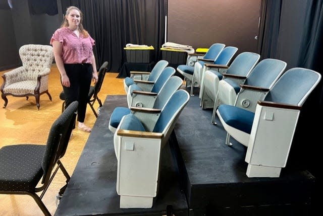 Andrea Young, ART president, stands next to some chairs her organization acquired from the old Florida Theater.
