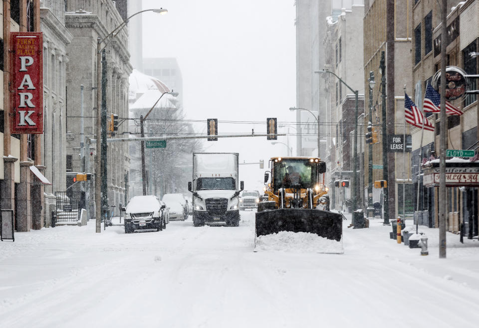 Ploughs clear streets downtown as snow falls on Monday, Jan. 15, 2024 in Memphis, Tenn. (Mark Weber/Daily Memphian via AP)