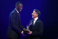 Usain Bolt of Jamaica (L) receives the Male World Athlete of the Year Award 2016 from IAAF's President Sebastian Coe in Monaco December 2, 2016. REUTERS/Eric Gaillard