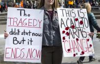 <p>An attendee holds two signs at the March for Our Lives 2018 event in Grand Rapids, Michigan, on Saturday, March 24, 2018. (Casey Sykes | MLive.com/AP) </p>